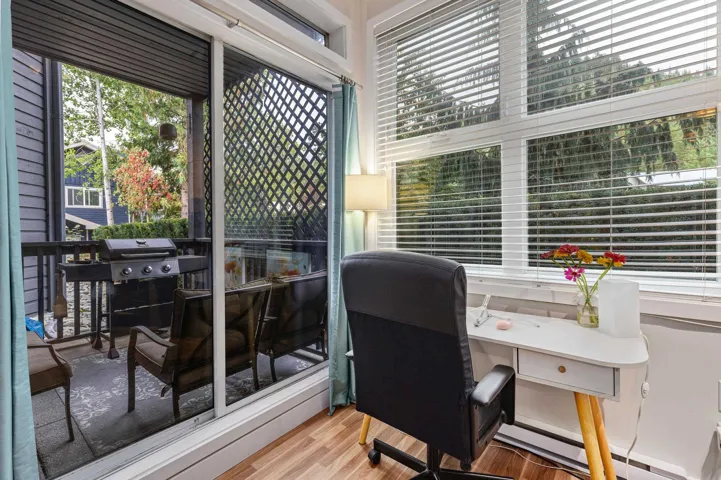 Home office featuring light wood finished floors and a baseboard radiator