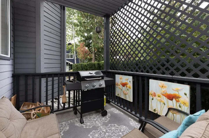 Balcony featuring area for grilling and outdoor lounge area