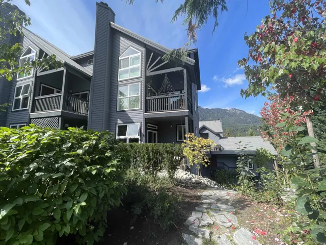 Front view of townhouse featuring a chimney and a mountain view