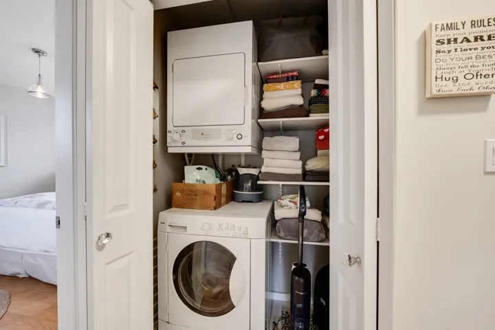 Laundry area with stacked washer and dryer