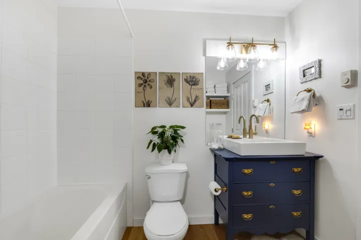 Full bathroom featuring vanity, wood finished floors, and shower / bath combination