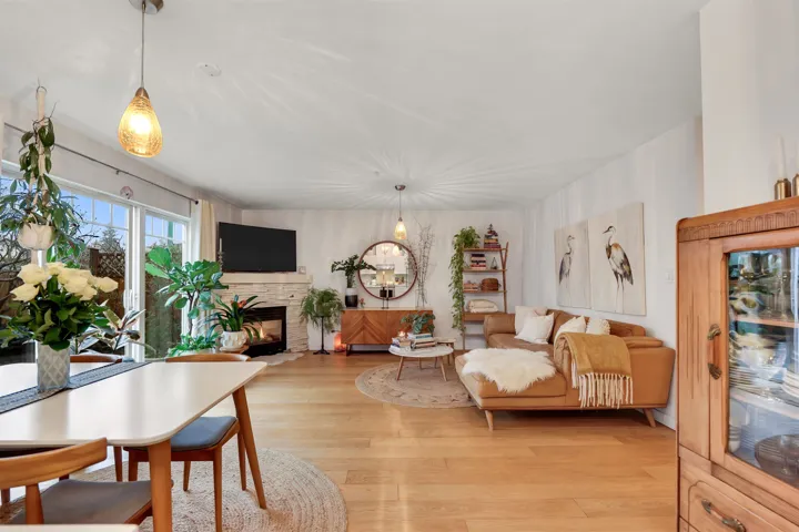 Living room featuring light wood-style flooring and a fireplace with flush hearth