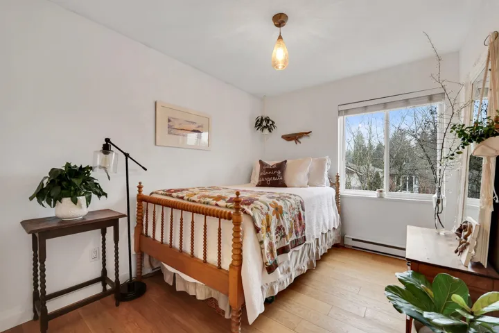 Bedroom featuring light wood finished floors and a baseboard radiator