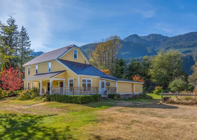 Exterior space with a yard, a mountain view, and metal roof