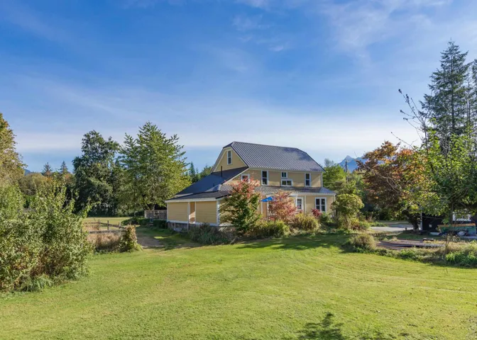 Rear view of house featuring a lawn