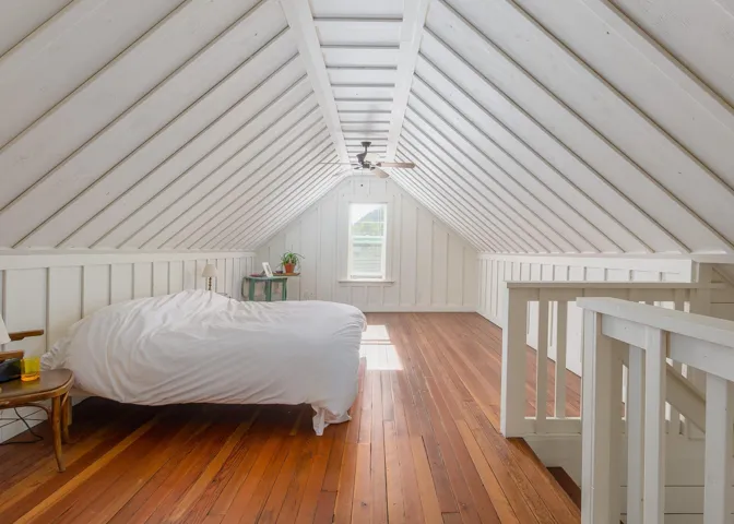 Bedroom with wood-type flooring and vaulted ceiling