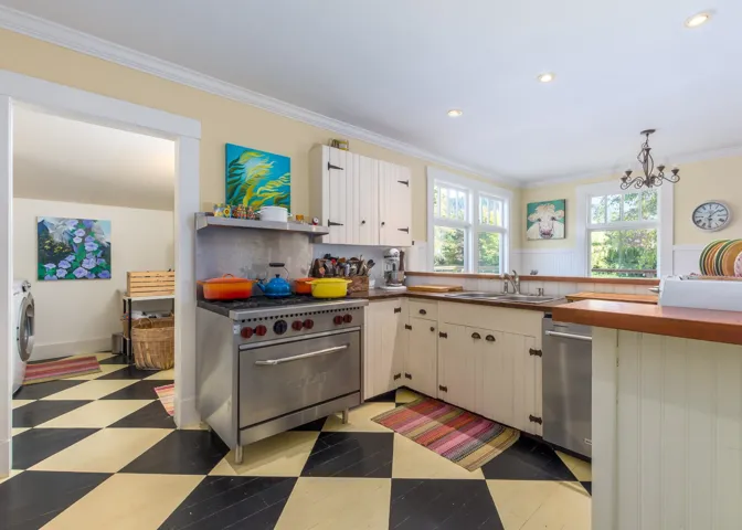 Kitchen featuring ornamental molding, a chandelier, recessed lighting, stainless steel appliances, and a sink