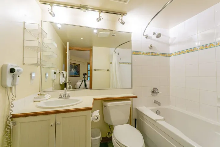 Full bath with shower / tub combo with curtain and vanity