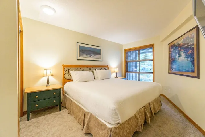 Bedroom featuring light carpet