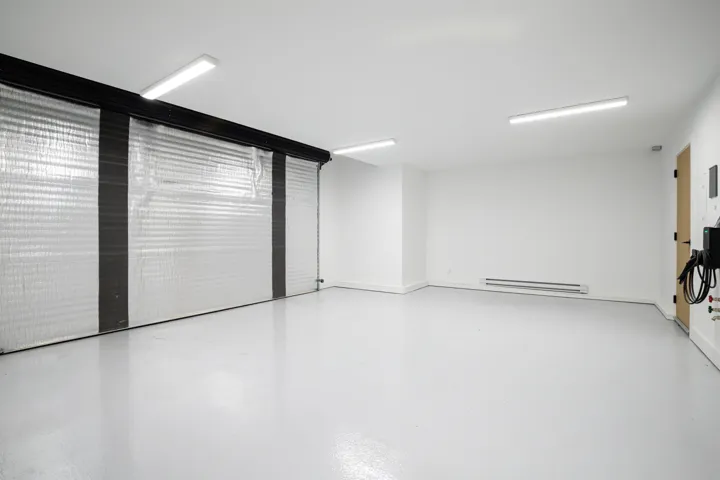 Unfurnished room featuring concrete flooring and a baseboard radiator