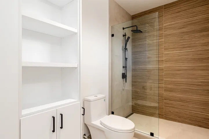 Full bath featuring walk in shower, light tile patterned floors, and a closet