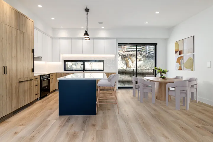 Kitchen featuring light brown cabinets, modern cabinets, hanging light fixtures, white cabinetry, and recessed lighting
