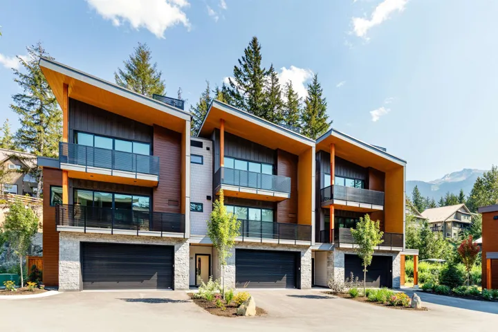 View of property with a mountain view, driveway, and an attached garage