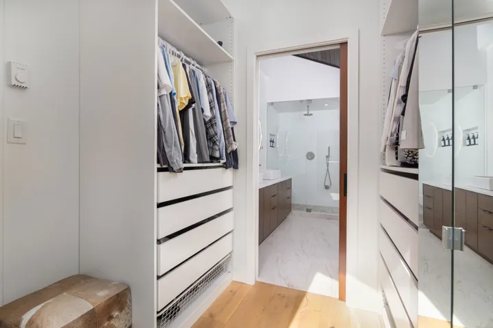 Walk in closet with light wood-type flooring