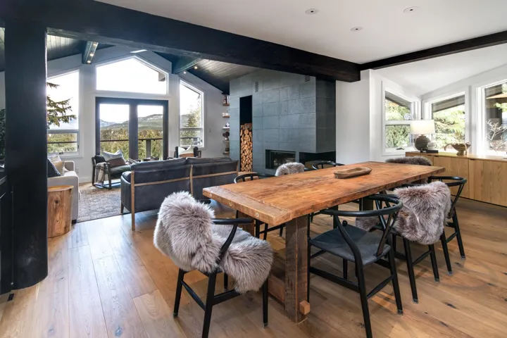 Dining room with light wood-type flooring, a tile fireplace, and a mountain view