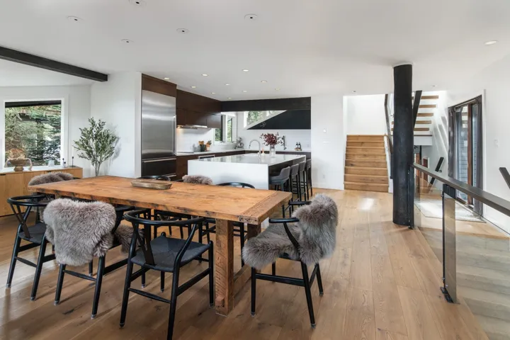 Dining space with light wood finished floors, stairway, and recessed lighting
