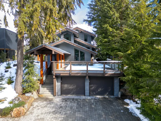 View of front facade featuring a deck, decorative driveway, and a garage