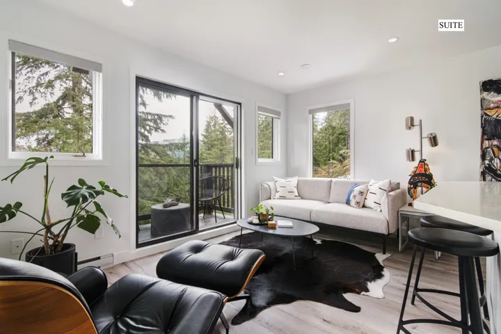 Living area featuring recessed lighting, light wood-type flooring, and a baseboard heating unit