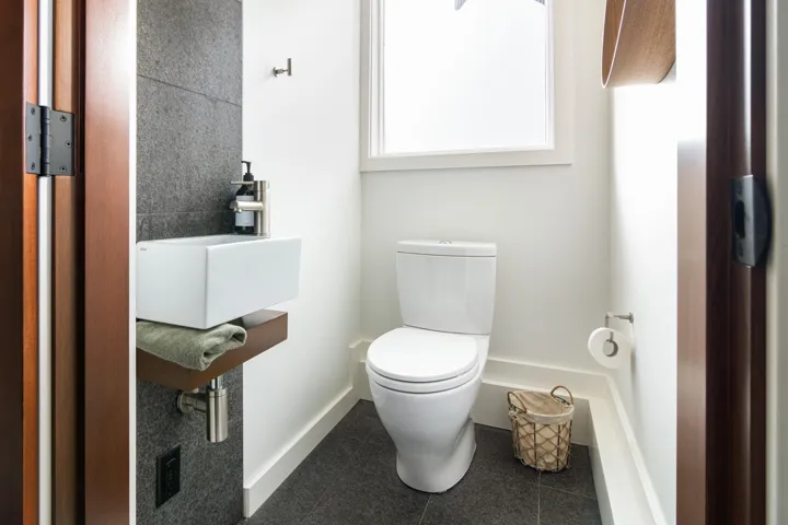 Half bathroom featuring a sink and tile patterned floors