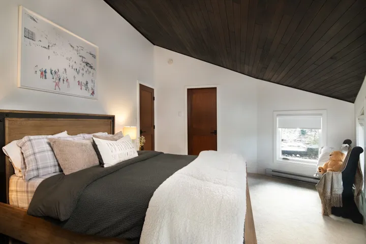 Bedroom featuring lofted ceiling, wooden ceiling, carpet flooring, and a baseboard heating unit