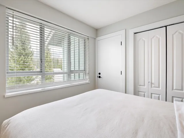 Bedroom featuring a closet and multiple windows