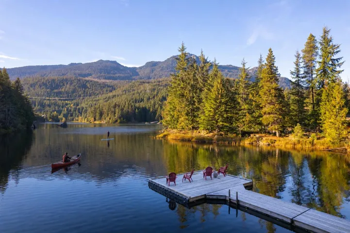 Expansive lakefront setting with a wooden dock