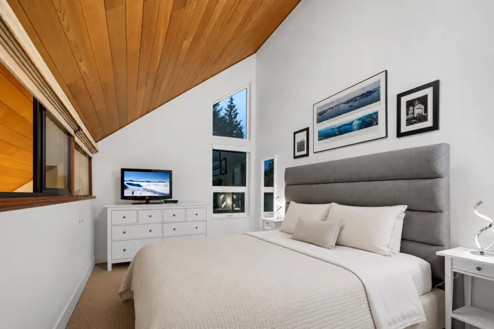 Expansive outdoor deck featuring wood flooring and a privacy screen