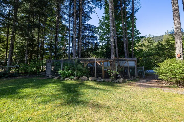 View of yard with an outdoor structure, exterior structure, and fence