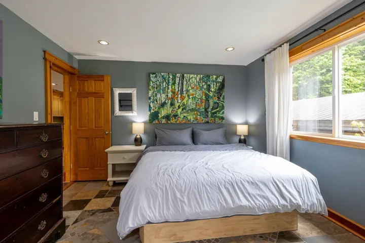 Bedroom featuring baseboards, stone finish flooring, and recessed lighting