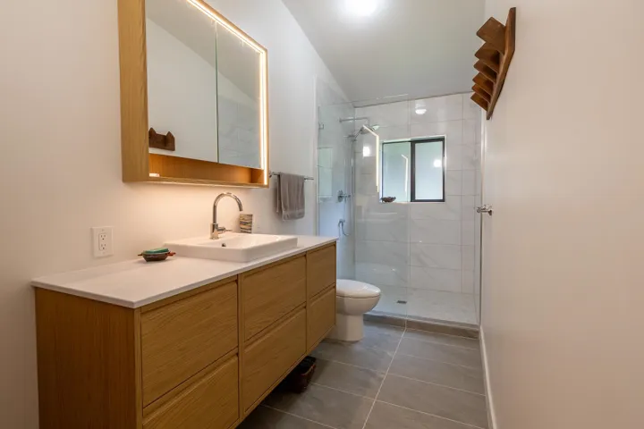 Bathroom with vanity, toilet, tile patterned flooring, and a stall shower