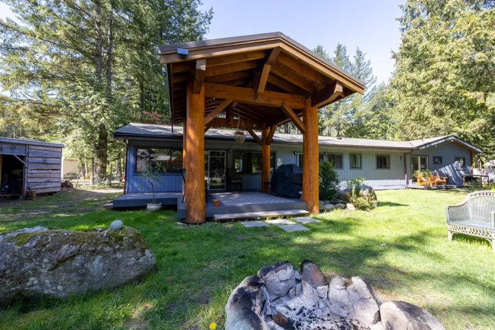 Exterior space featuring a deck and a lawn