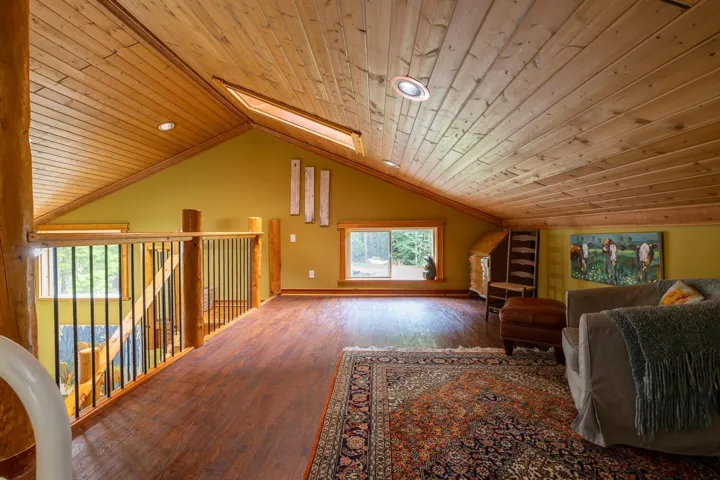Bonus room featuring wooden ceiling, wood finished floors, and lofted ceiling with skylight