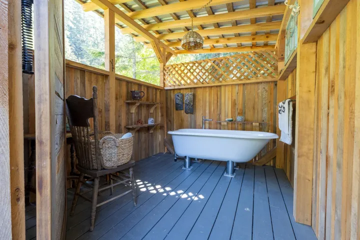 Bathroom with wood walls, wood-type flooring, and a freestanding tub
