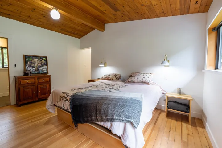 Bedroom with hardwood / wood-style flooring, wood ceiling, lofted ceiling with beams, and baseboards