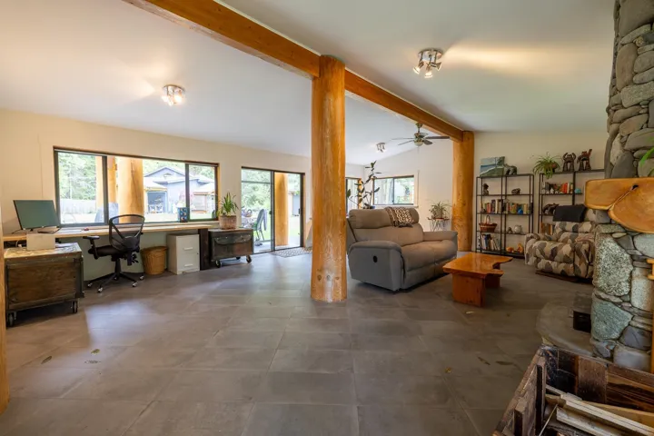 Living room featuring lofted ceiling with beams and ceiling fan