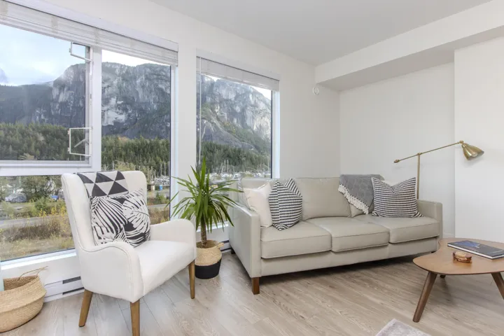 Living room featuring wood finished floors, a mountain view, and baseboard heating