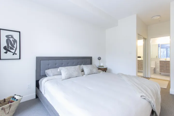 Bedroom with carpet floors and connected bathroom
