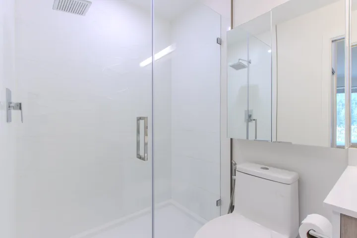 Bathroom featuring a shower stall and vanity