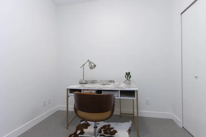 Carpeted office with baseboards