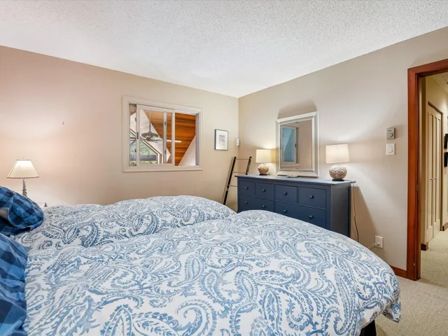 Carpeted bedroom with baseboards and a textured ceiling