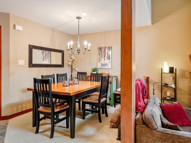 Dining room featuring baseboards, carpet flooring, and an inviting chandelier