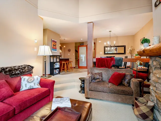 Living area with carpet floors and a notable chandelier