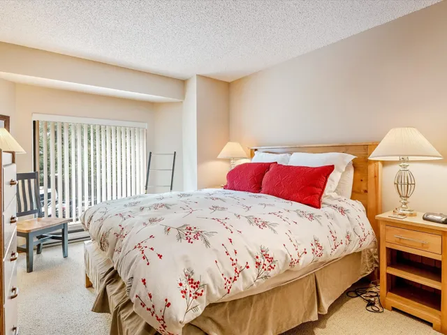 Bedroom featuring carpet flooring, a textured ceiling, and access to outside