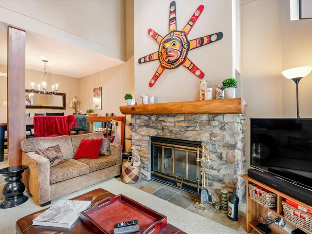 Living area with a fireplace and a chandelier