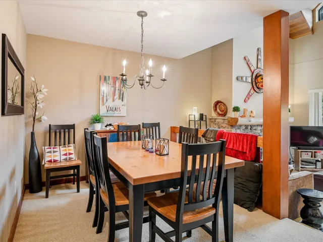 Dining area featuring a notable chandelier and light carpet