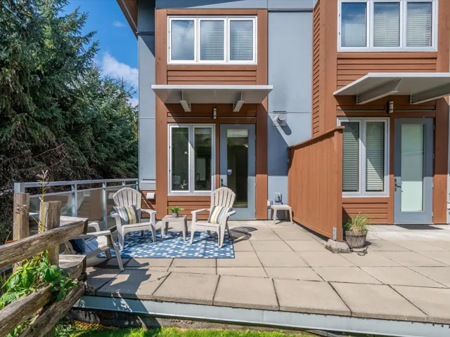 Back of property with a patio and stucco siding