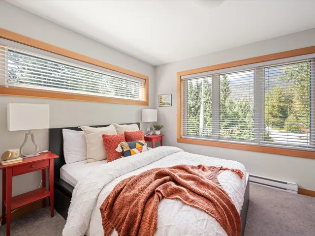 Carpeted bedroom with baseboard heating