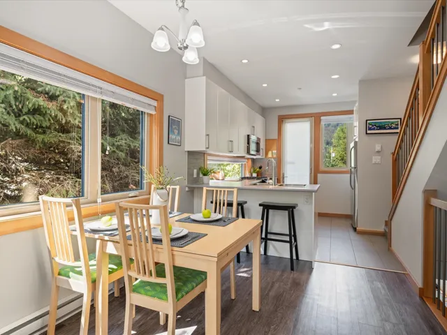 Dining area featuring dark wood-style flooring, stairway, recessed lighting, and a chandelier