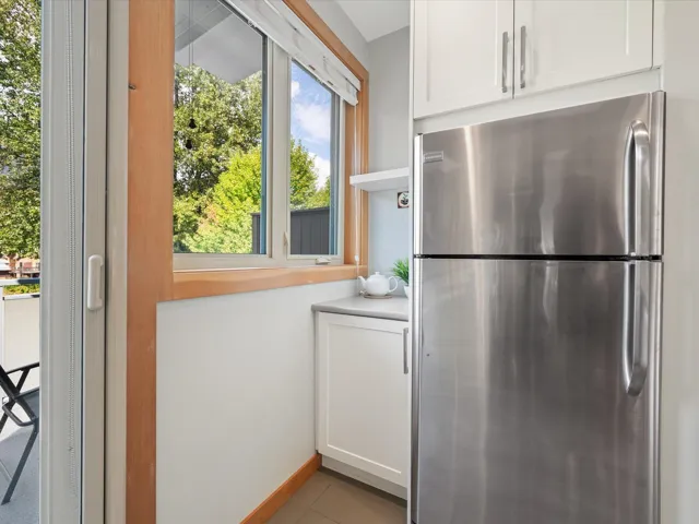 Doorway to outside featuring baseboards and tile patterned flooring