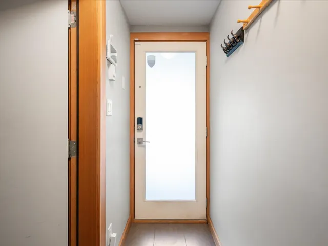 Doorway to outside featuring baseboards and tile patterned flooring